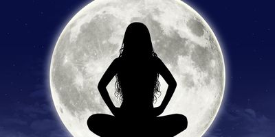 Silhouette-of-young-woman-in-meditation-pose-full-moon-in-virgo-in-the-background