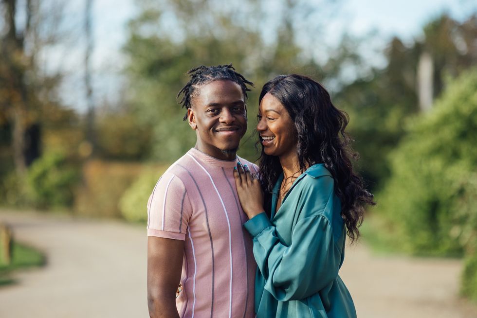 Loving-couple-sharing-an-embrace-posing-for-camera