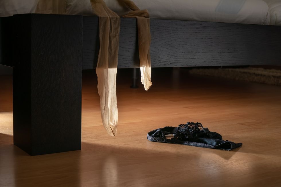 pantyhose-black-underwear-hanging-and-falling-off-side-of-bed-and-onto-hardwood-floor