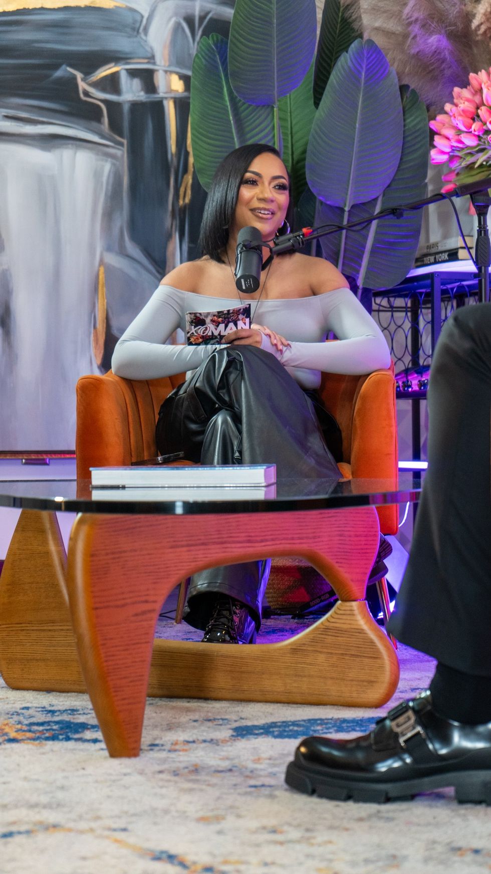 Portrait of Kiara Walker smiling confidently, as she hosts a podcast, embodying media presence