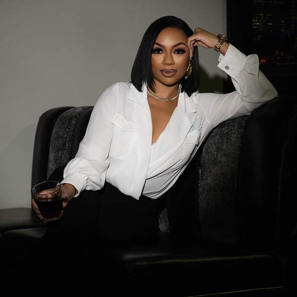 Portrait of xoMAN podcast host Kiara Walker staring confidently at the camera