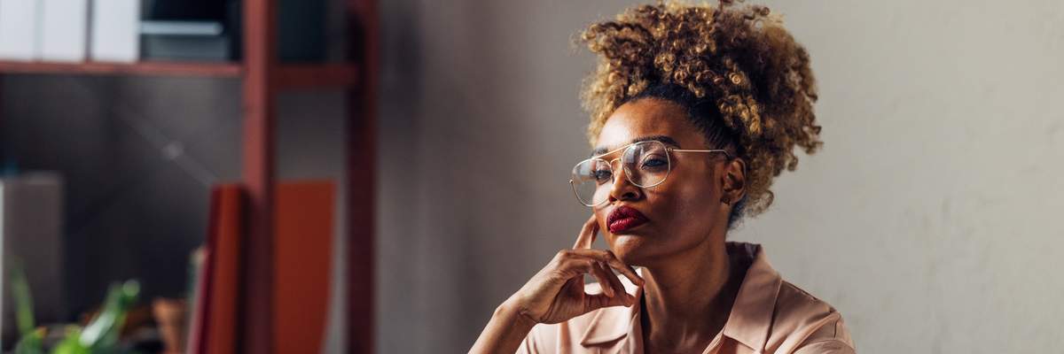 Quiet-Black-woman-deep-in-serious-thought-thinking-in-the-workplace