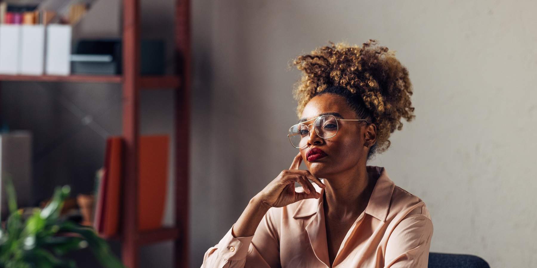 Quiet-Black-woman-deep-in-serious-thought-thinking-in-the-workplace