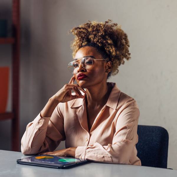 Quiet-Black-woman-deep-in-serious-thought-thinking-in-the-workplace