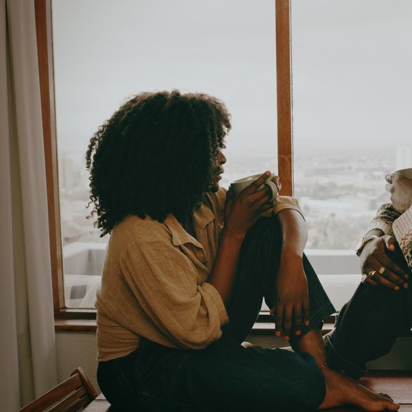 Shot-of-a-young-couple-talking-over-coffee-by-a-window