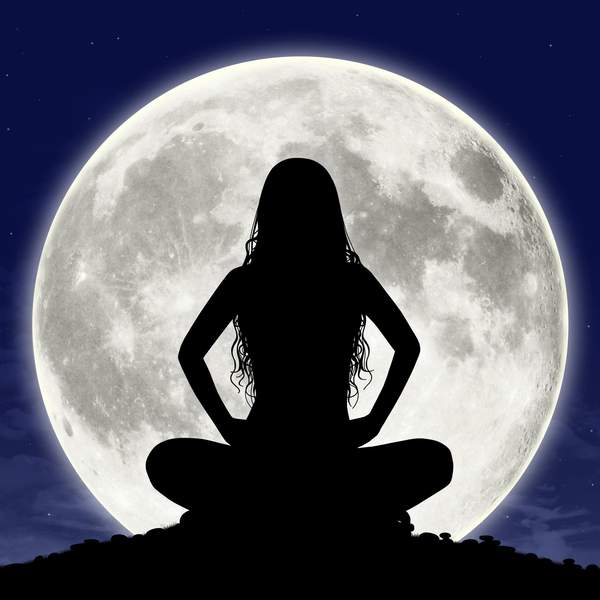 Silhouette-of-young-woman-in-meditation-pose-full-moon-in-virgo-in-the-background