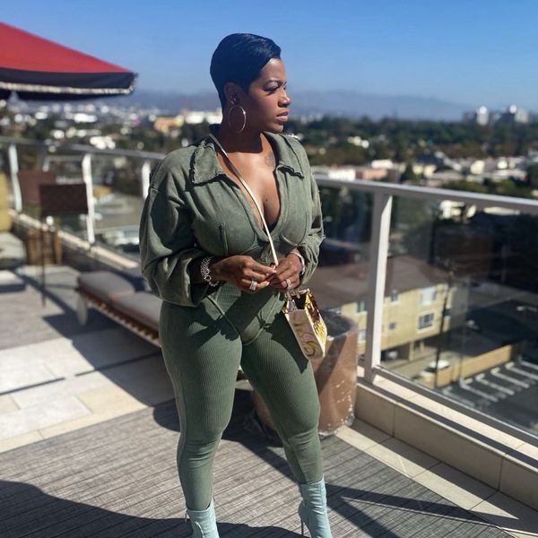 Singer-actress-Fantasia-wearing-olive-green-outfit-looking-off-to-the-side-as-she-poses-on-balcony