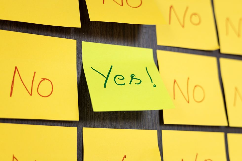 the-word-yes-on-a-sticky-note-around-other-sticky-notes-that-read-no