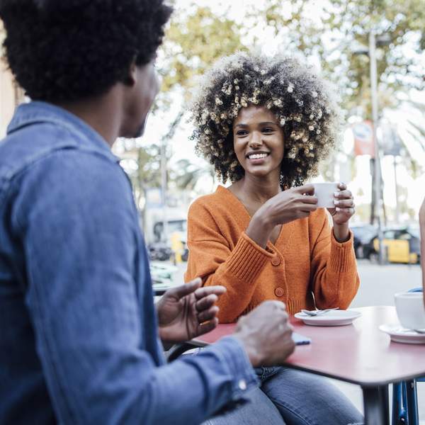 Three-people-laughing-enjoying-conversation-in-public-setting