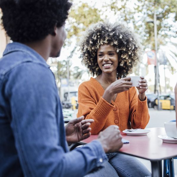 Three-people-laughing-enjoying-conversation-in-public-setting