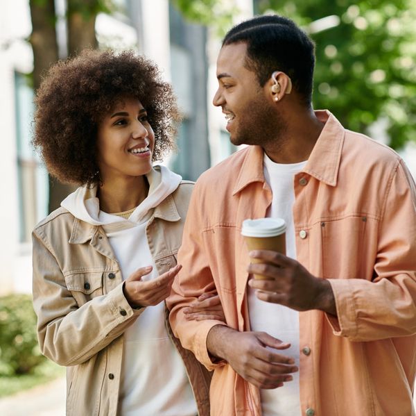 Two friends walking close and laughing, hinting at possible romantic chemistry