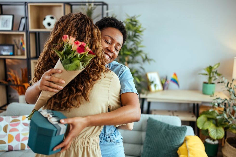 Two-women-embracing-amid-gift-giving