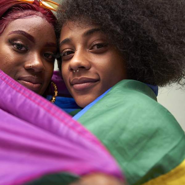 Two-women-wrapped-in-Pride-Flag