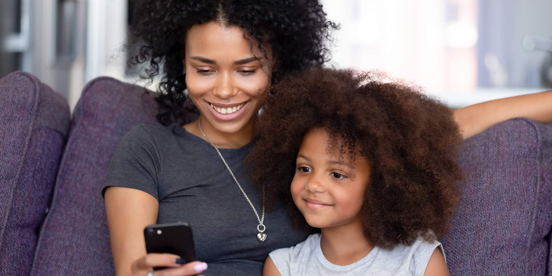 woman and child browsing on phone