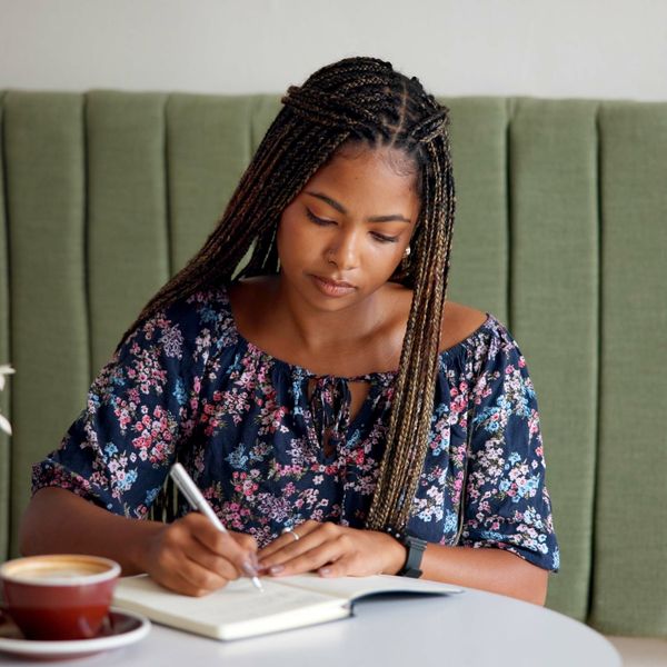 Woman journaling through inner child healing with soft lighting