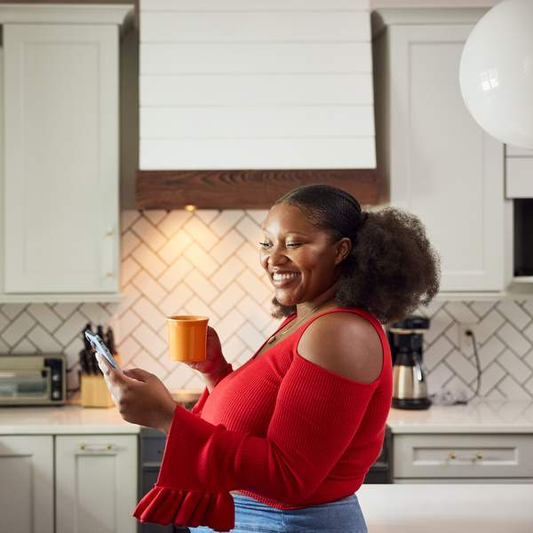 Woman-smiling-in-her-kitchen-buying-her-first-home