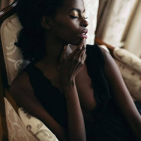 young-Black-woman-in-lingerie-with-her-eyes-closed-feeling-pleasure