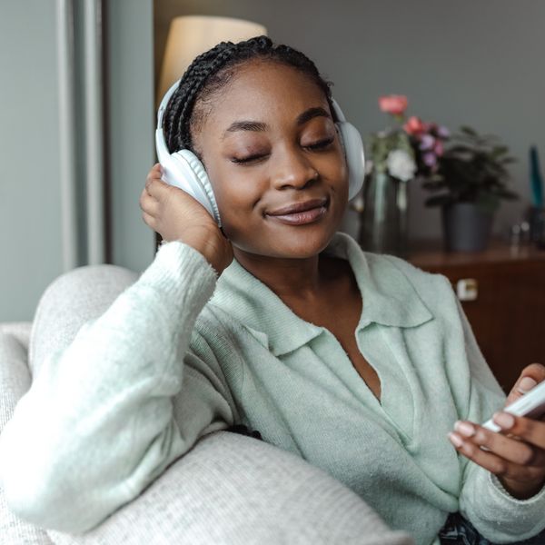 young-Black-woman-listening-to-music-peacefully-on-wireless-headphones
