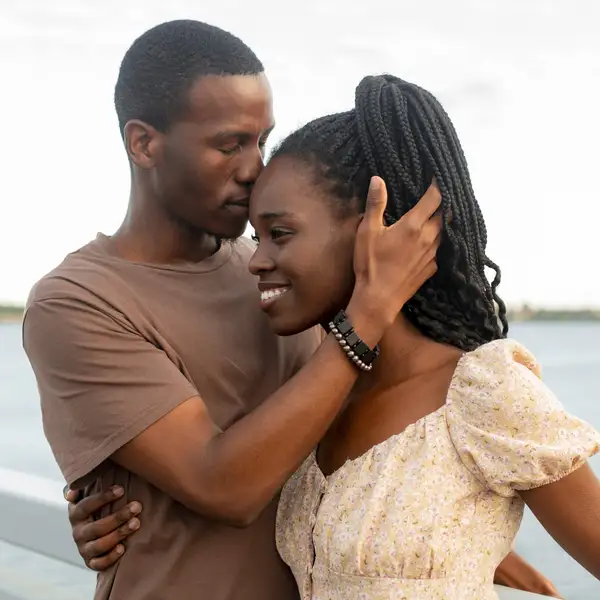 Young-man-kissing-girlfriend-by-the-river-at-sunset-scorpio-man-pisces-woman-love-compatibility