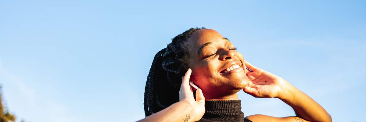 Young-woman-dancing-in-the-park-feeling-free-proud-self-love