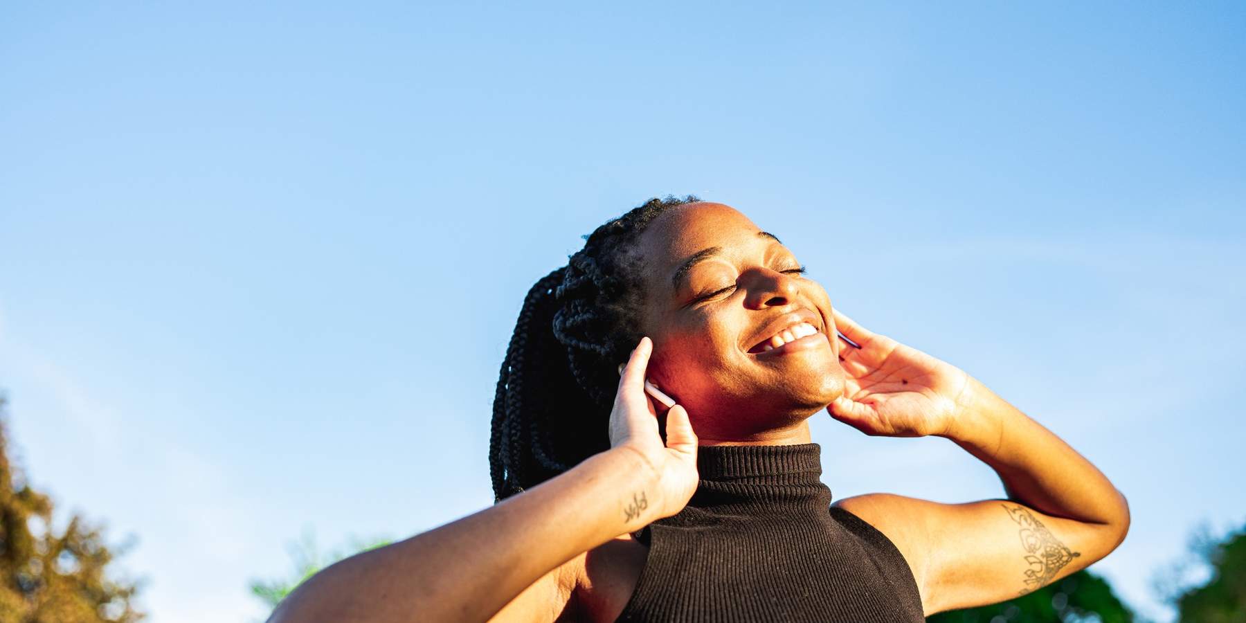 Young-woman-dancing-in-the-park-feeling-free-proud-self-love