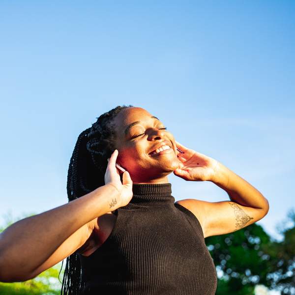 Young-woman-dancing-in-the-park-feeling-free-proud-self-love