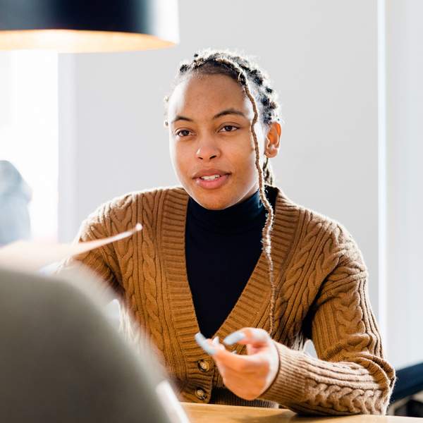 young-woman-handing-resume-to-job-interviewer