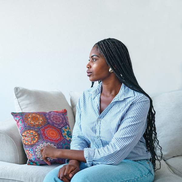 Young-woman-sitting-thinking-on-the-couch