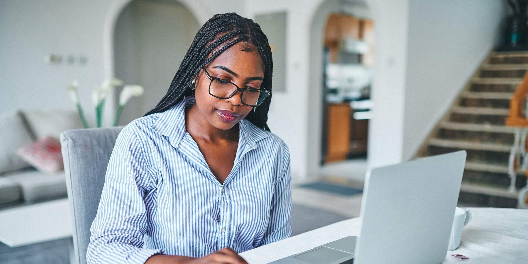 young-woman-working-on-her-budget-at-home-on-tablet-and-laptop